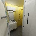 koupelna - pohled od vstupních dveří, napravo sprchový kout a úložné prostory
